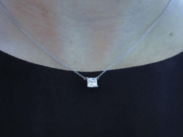 Platinum Tiffany & Co. Princess Cut Diamond Solitaire Pendant on neck